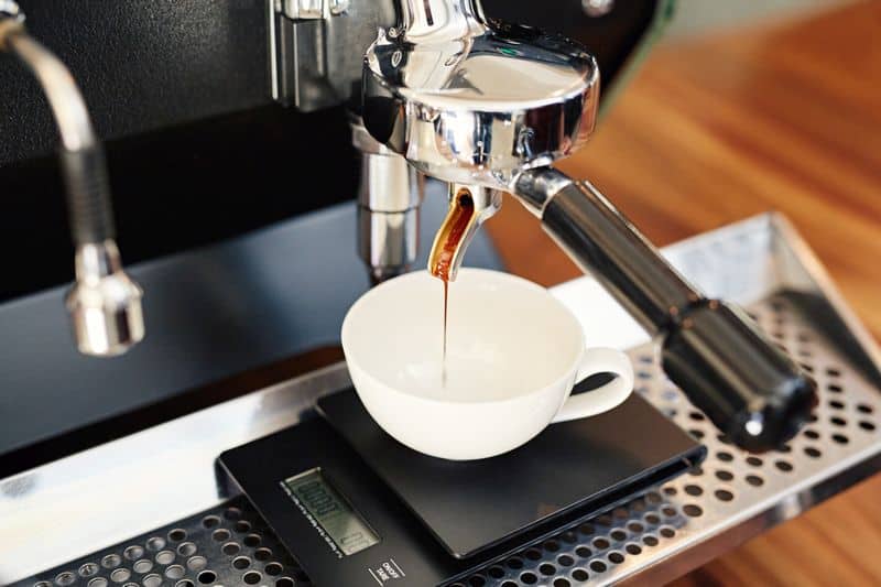 Espresso scale weighing espresso pouring into cup