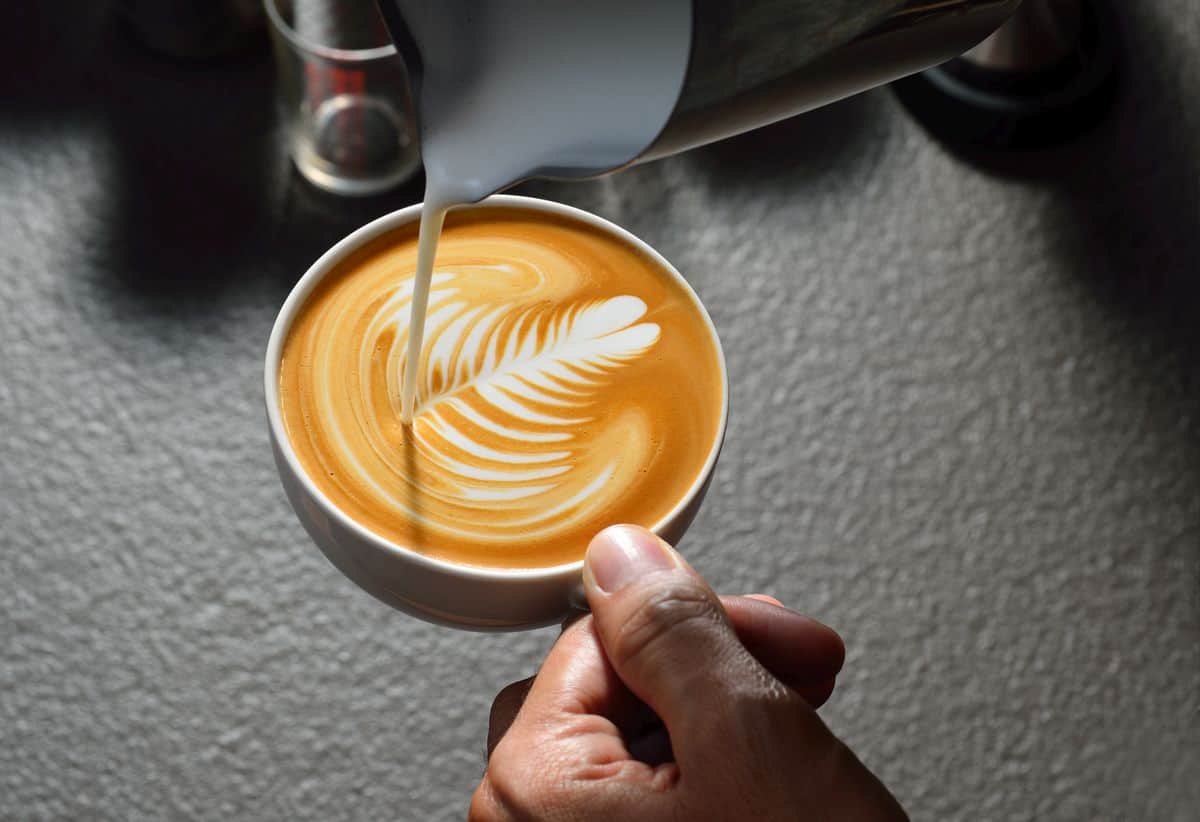 best milk frother pouring milk into cup to make latte art