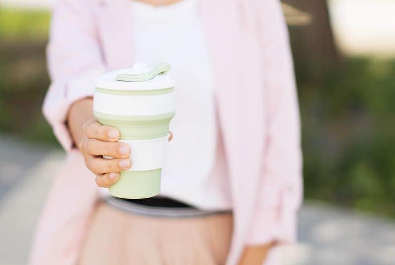 Female hands hold reusable coffee mug. Zero waste concept. Sustainable lifestyle.
