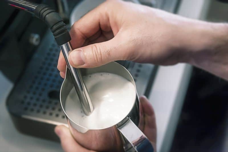 Milk frother jug frothing milk