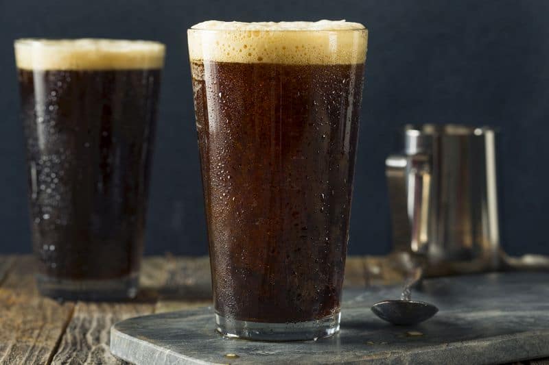 Frothy nitro cold brew coffee in tall glass