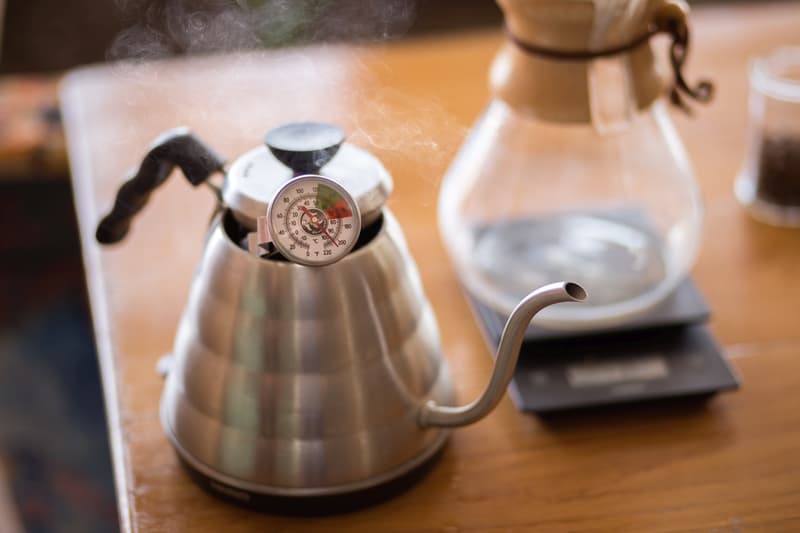 Close up of pour over coffee kettle with thermometer.