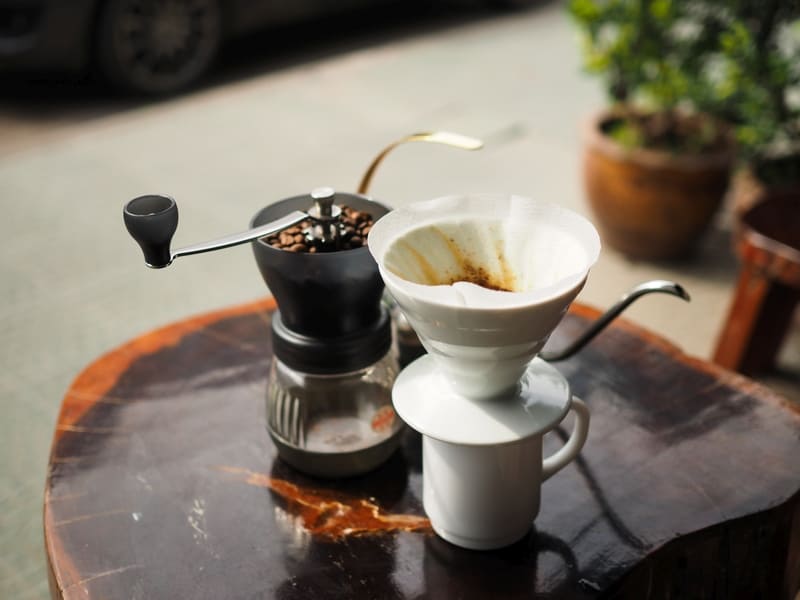 Porcelain pour over coffee maker on table.