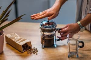 Pot of french press cold brew coffee on table