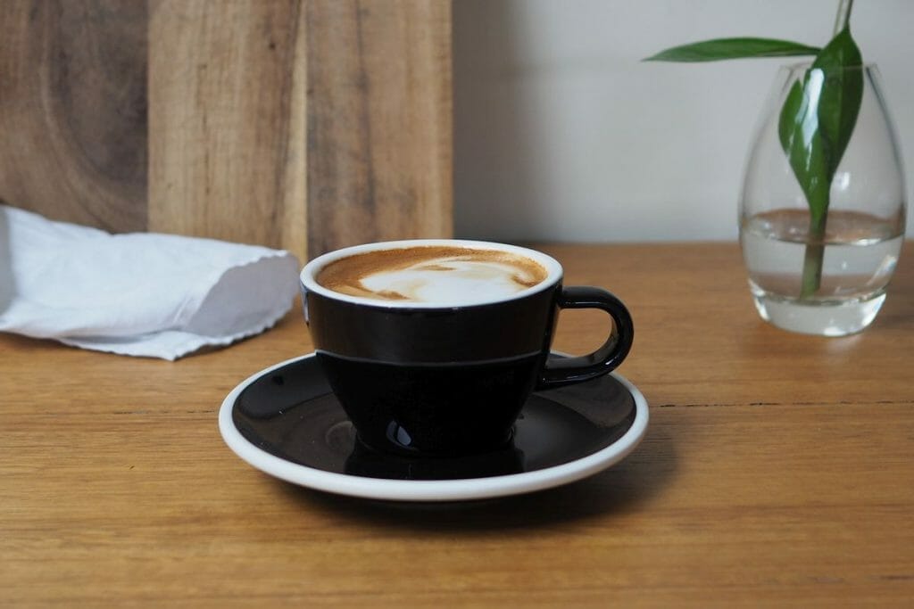 cup of magic coffee in black ceramic cup.