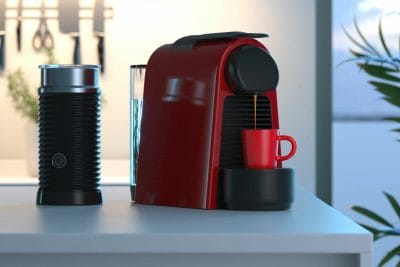 Red nespresso coffee capsule machine with Aeroccino on kitchen bench