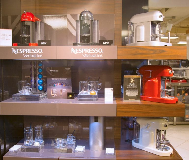 Nespresso coffee machine store with classic and vertuo machines on display.