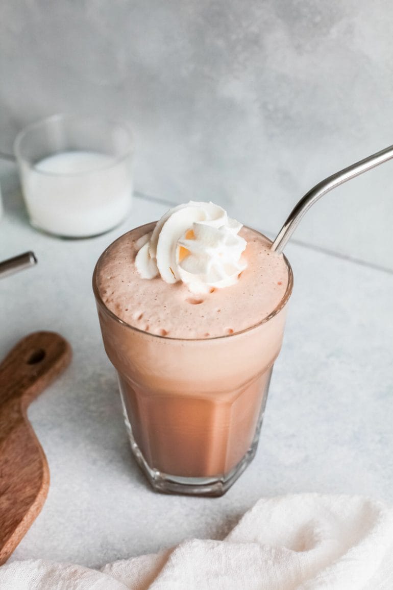 Nutella iced coffee frappe in glass with straw.