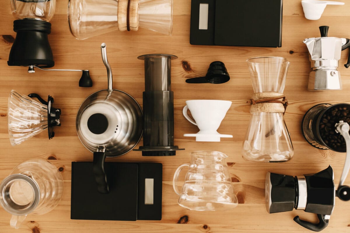 Coffee accessories top view. Stylish barista accessories for coffee brewing on wooden table.