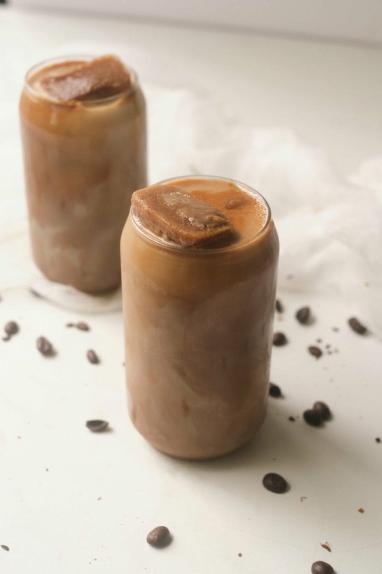 brown sugar iced coffee with coffee ice cubes in glass.