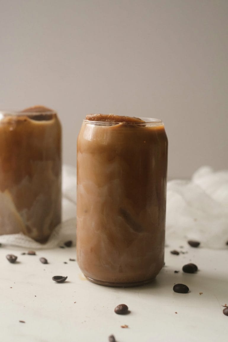Two glass cans with sweet iced coffee with brown sugar.