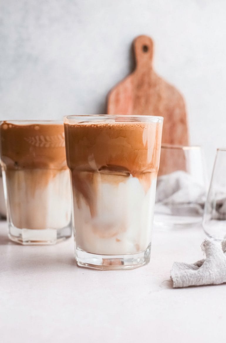 Two tall glasses of Greek Iced Coffee.