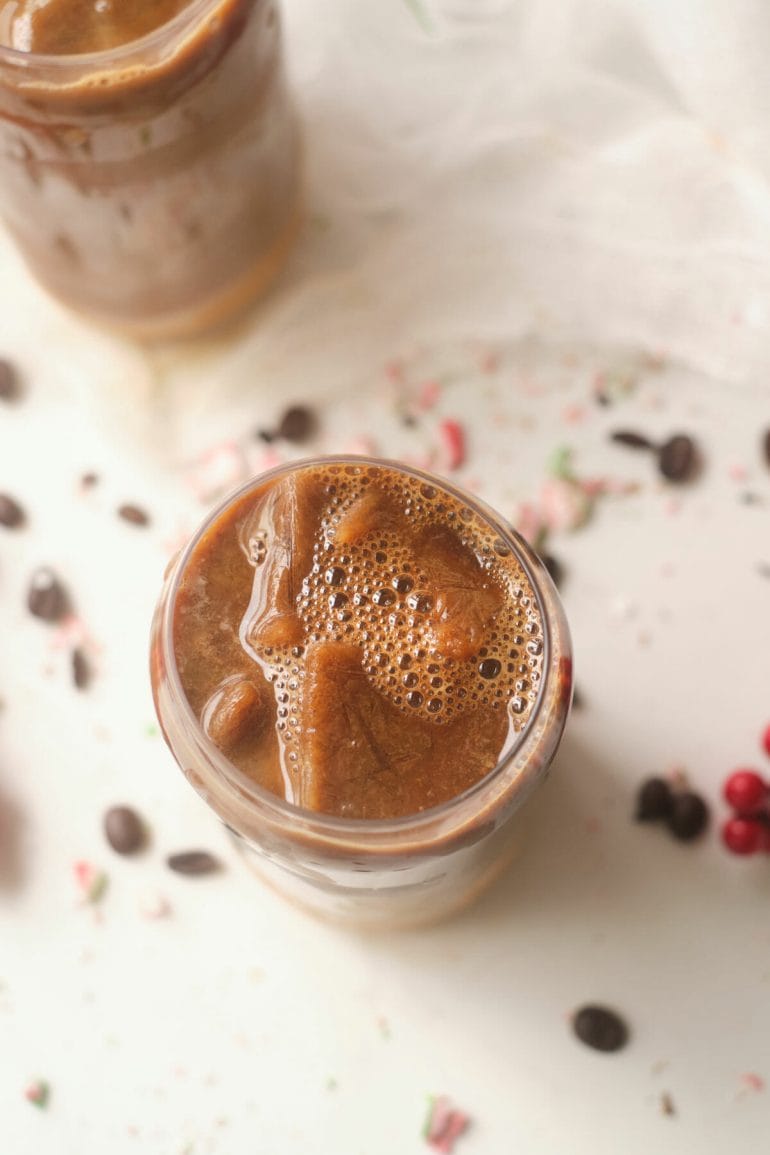 Top view of dulce de leche iced latte in glass.