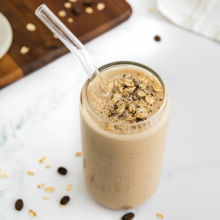 breakfast coffee smoothie without banana in glass with straw.